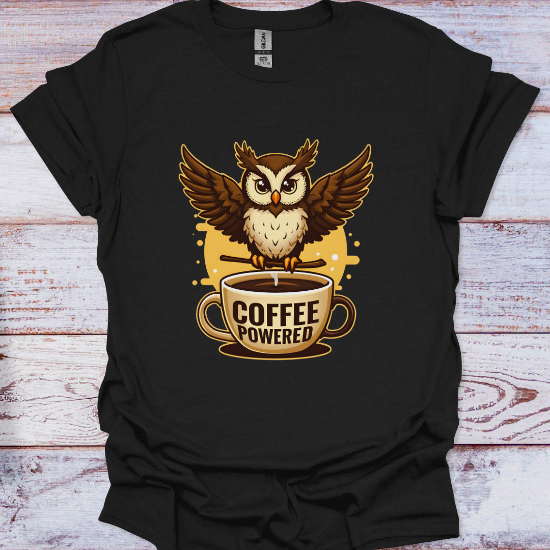 Black t-shirt with an owl and coffee cup graphic on a wooden surface