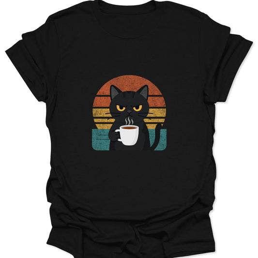 A black t-shirt featuring a grumpy black cat holding a steaming white coffee mug centered in front of an orange and teal retro sunset.