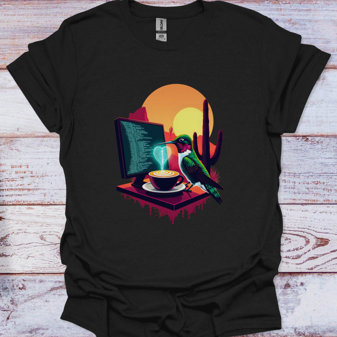 Black t-shirt with a colorful graphic of a computer, coffee cup, and hummingbird on a wooden surface