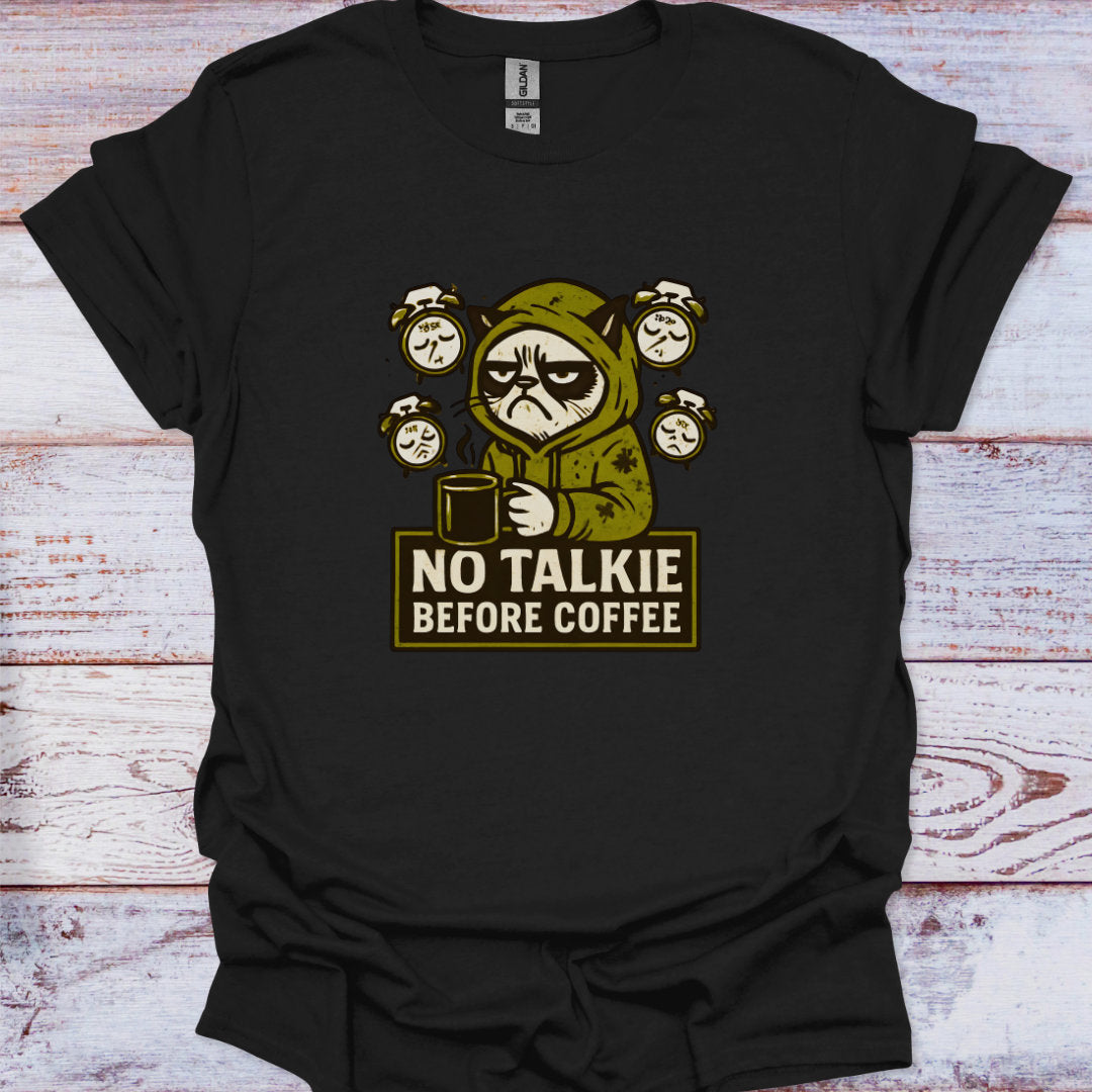 Black t-shirt with a graphic of a character holding a coffee cup and text 'No Talkie Before Coffee' on a wooden surface.