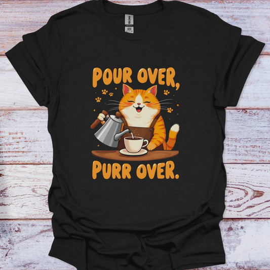 Black t-shirt with a cat pouring coffee design and text 'Pour Over, Purr Over' on a wooden surface.