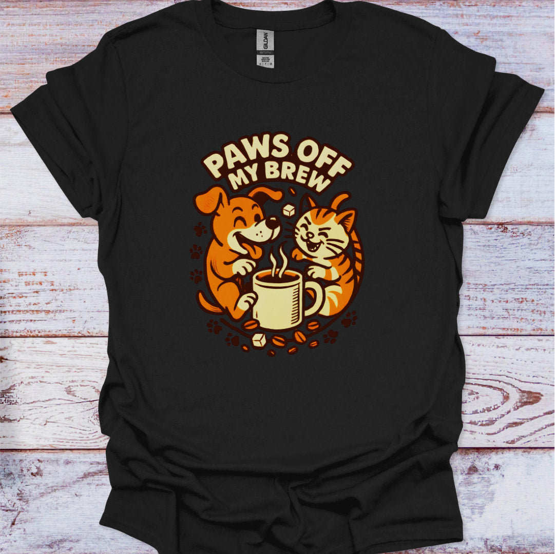 Black t-shirt with a graphic of a dog and cat holding a coffee cup and text 'Paws Off My Brew' on a wooden surface.