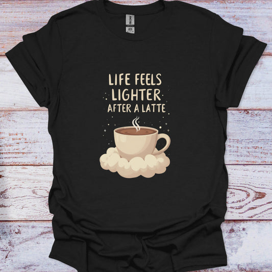 Black t-shirt with a coffee cup graphic and text 'Life feels lighter after a latte' on a wooden surface.