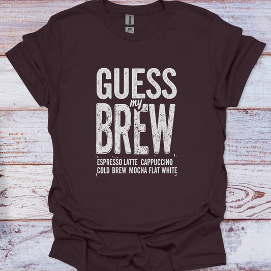 Brown t-shirt with 'Guess my Brew' text on a wooden surface