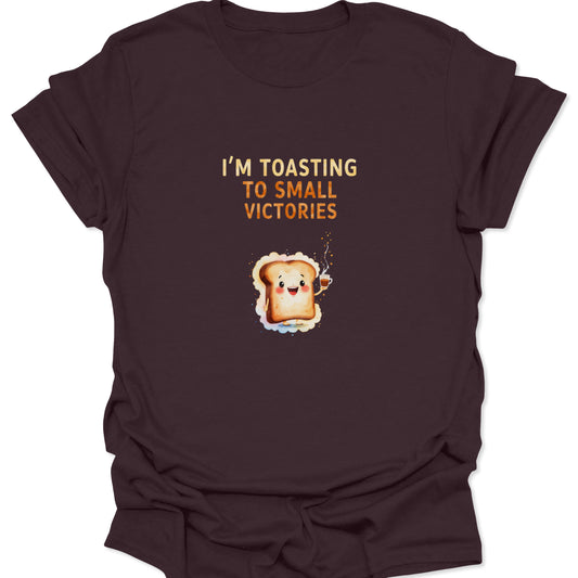 Dark Chocolate t-shirt featuring cute toast character raising a coffee cup with "Toasting To Small Victories" text.