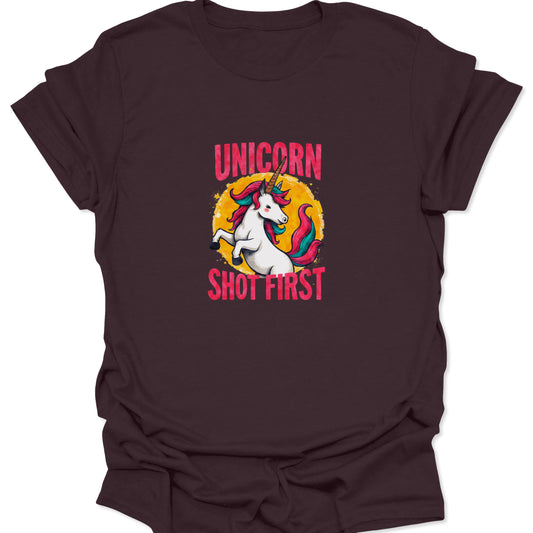 Dark brown t-shirt featuring a cinematic quote parody graphic of a colorful unicorn and sunburst with "Unicorn Shot First."
