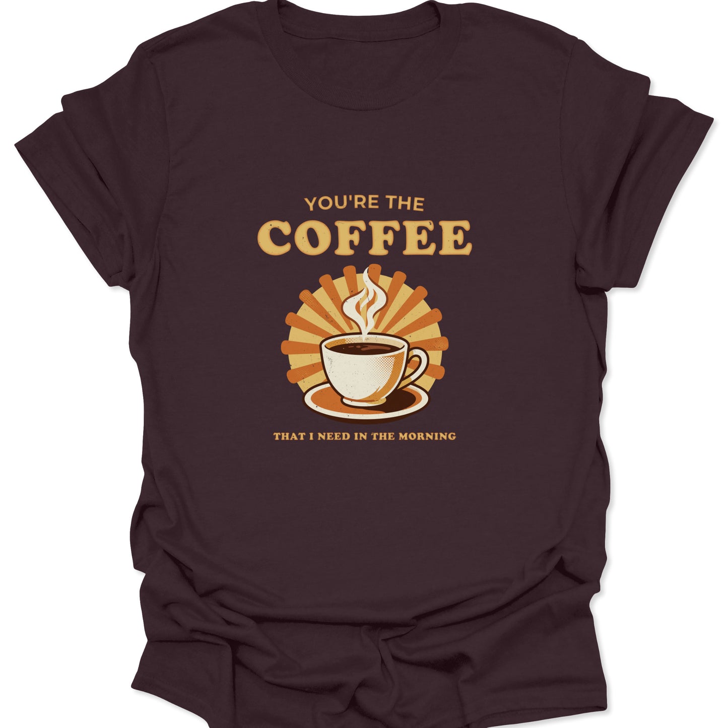 Dark chocolate brown shirt displaying a vintage-inspired coffee cup illustration with a warm orange sunburst and morning-themed typography.