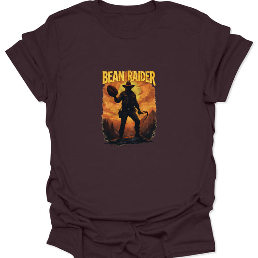 Dark brown t-shirt featuring a distressed, pulp-style graphic of a coffee adventurer with a whip and a massive roasted coffee bean treasure.