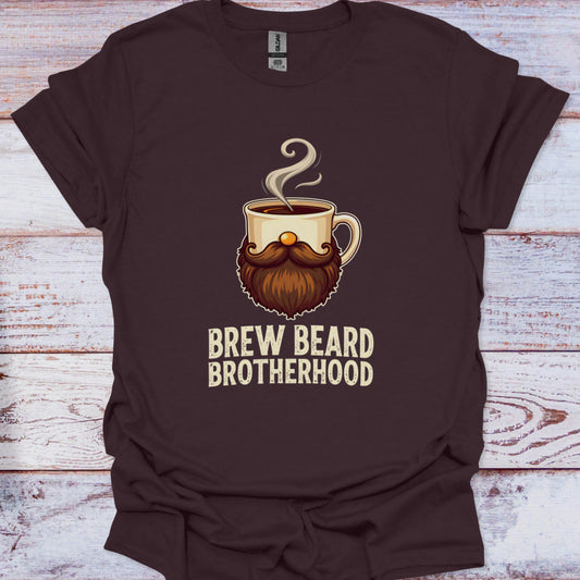 Brown t-shirt with a graphic of a coffee cup with a beard and the text 'Brew Beard Brotherhood' on a wooden surface.