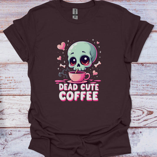 Brown t-shirt with a skull drinking coffee graphic and 'Dead Cute Coffee' text on a wooden surface.