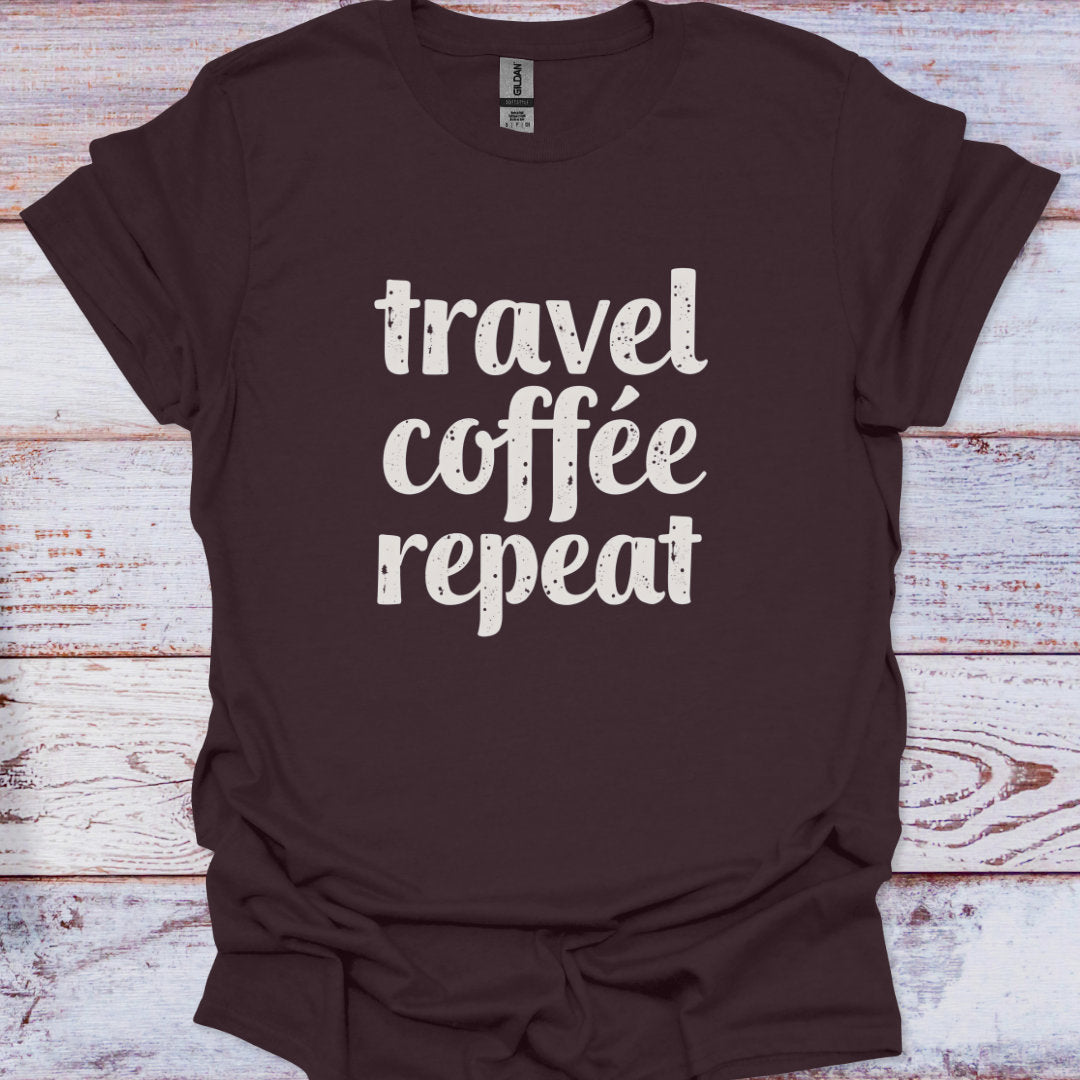 Brown t-shirt with 'travel coffee repeat' text on a wooden surface