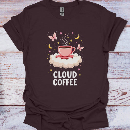 Brown t-shirt with 'Cloud Coffee' design featuring a pink cup on a cloud, butterflies, and stars on a wooden surface.