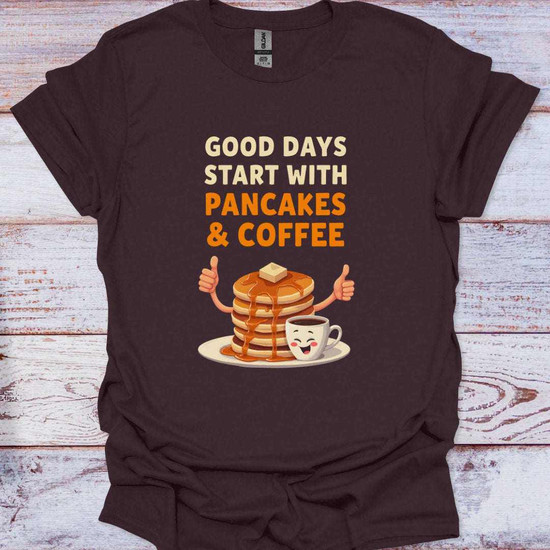 Brown t-shirt with 'Good days start with pancakes & coffee' graphic on a wooden surface
