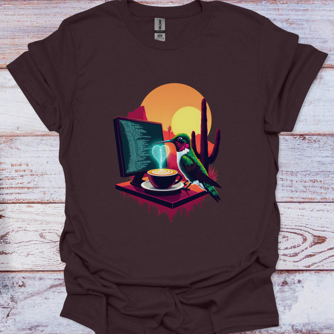 Brown t-shirt with a graphic of a bird, computer, and coffee cup on a wooden surface