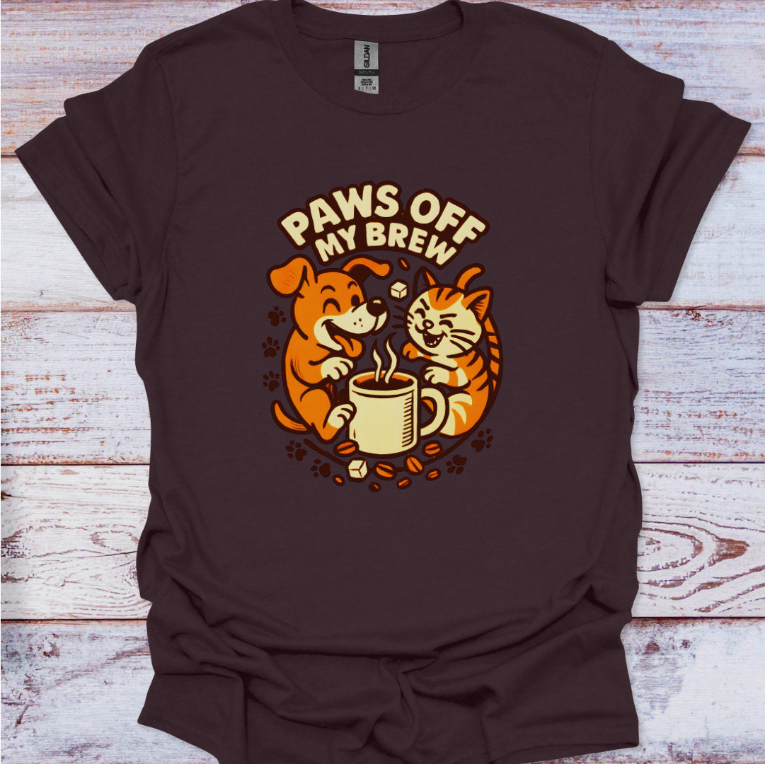 Brown t-shirt with a graphic of a dog and cat drinking coffee and 'Paws Off My Brew' text on a wooden surface.