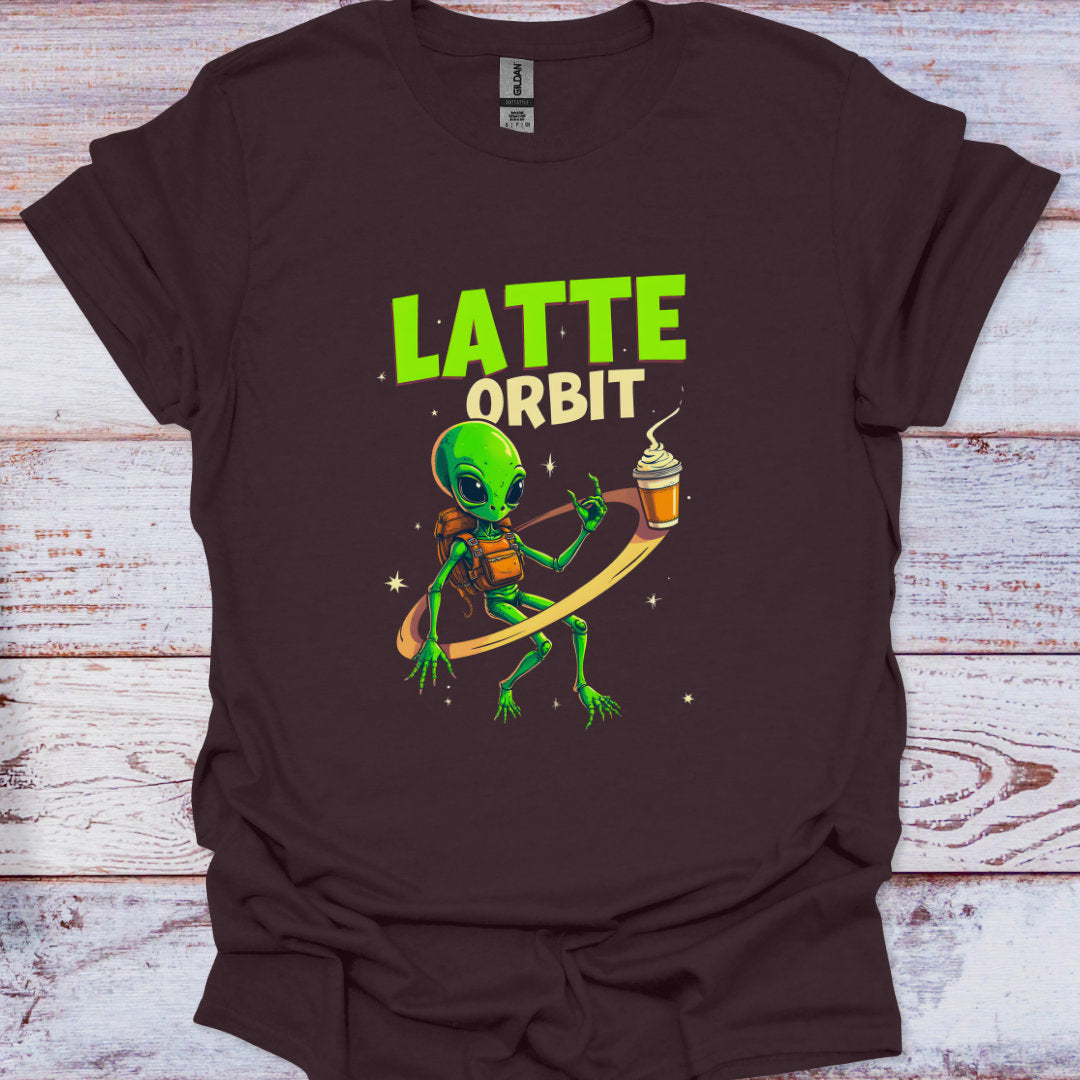 Brown t-shirt with an alien holding a coffee cup and 'Latte Orbit' text on a wooden surface