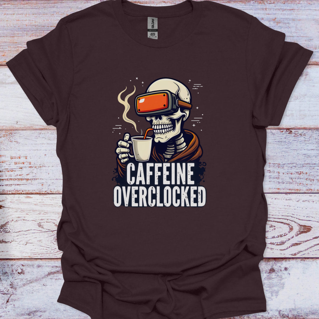 Brown t-shirt with a skeleton wearing VR goggles and holding a coffee cup, text 'Caffeine Overclocked' on a wooden surface.