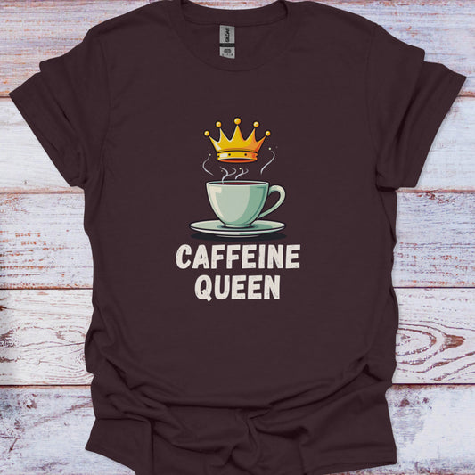 Brown t-shirt with a coffee cup and crown graphic and 'CAFFEINE QUEEN' text on a wooden surface.