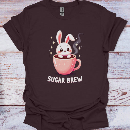 Brown t-shirt with a cartoon bunny in a coffee cup and 'Sugar Brew' text on a wooden surface