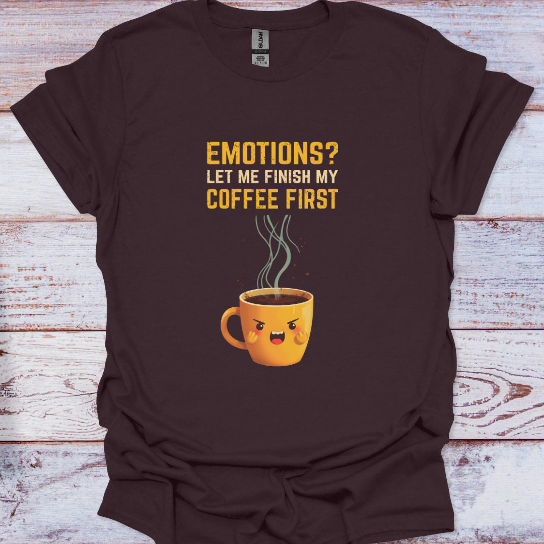 Brown t-shirt with a coffee cup graphic and text on a wooden surface