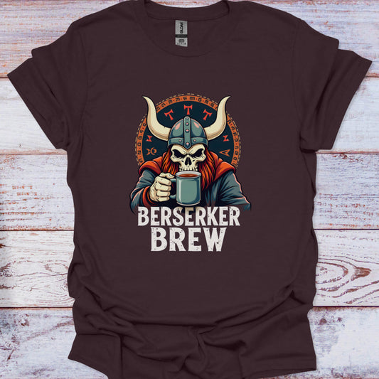 Brown t-shirt with a graphic of a skull in a Viking helmet holding a mug, labeled 'Berserker Brew', on a wooden surface.