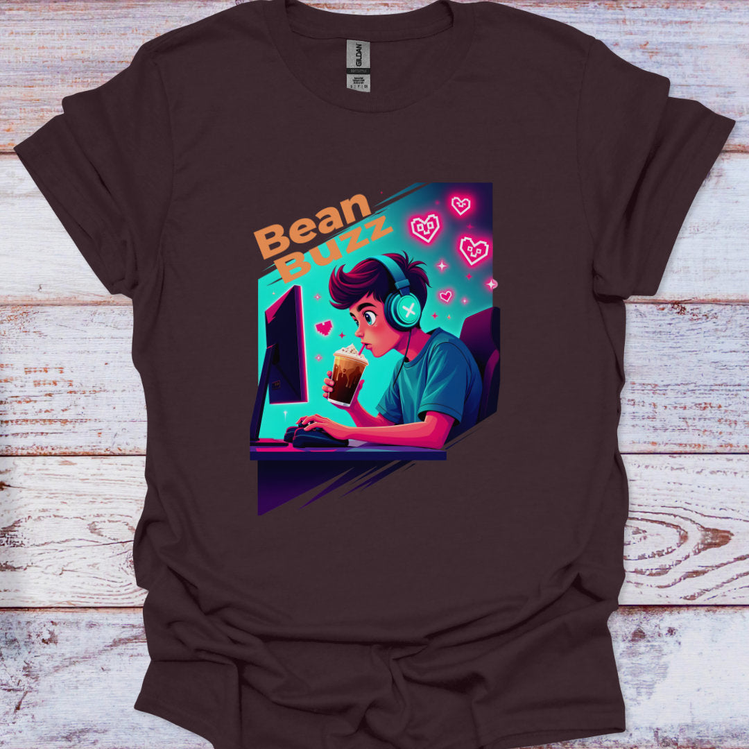 Brown t-shirt with a graphic design of a person using a computer and 'Bean Buzz' text on a wooden surface.