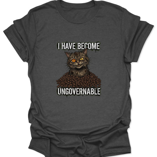 A gritty illustration of a wired cat in a mountain of coffee beans with bold white text, displayed on a textured dark heather gray fabric.