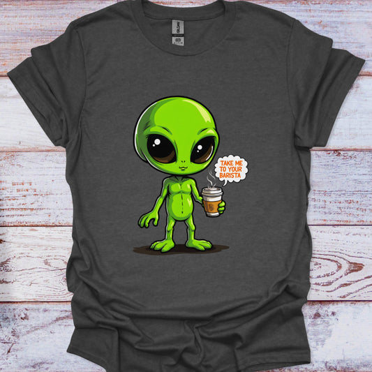 Gray t-shirt with a green alien holding a coffee cup graphic on a wooden surface