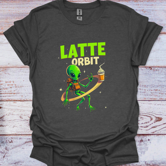 Dark gray t-shirt with a green alien holding a coffee cup and 'Latte Orbit' text on a wooden surface.