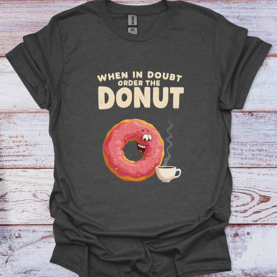 Dark gray t-shirt with a cartoon donut and coffee cup graphic and text on a wooden surface.