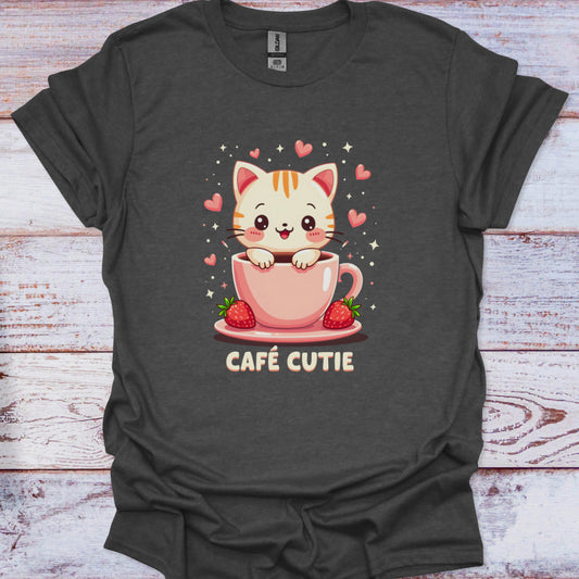 Dark gray t-shirt with a cute cat in a pink cup design and 'Café Cutie' text on a wooden surface.