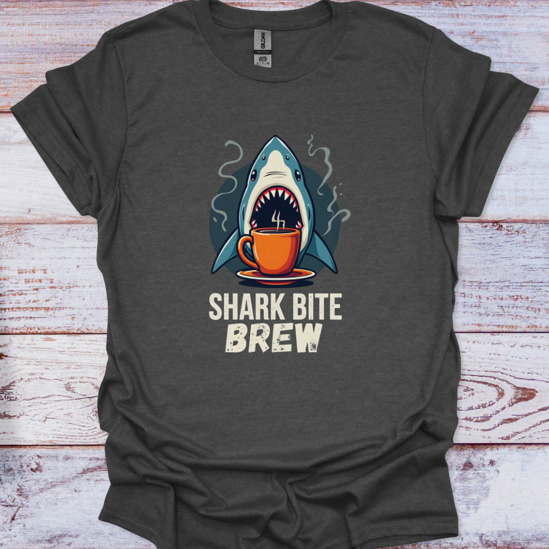 Gray t-shirt with a shark drinking from a coffee cup graphic and 'Shark Bite Brew' text on a wooden surface.