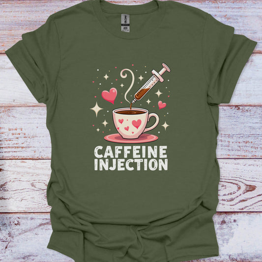 Green t-shirt with a graphic of a coffee cup and syringe labeled 'Caffeine Injection' on a wooden surface.