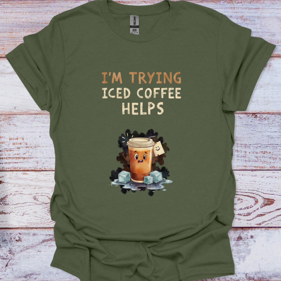 Green t-shirt with iced coffee graphic and text on a wooden surface