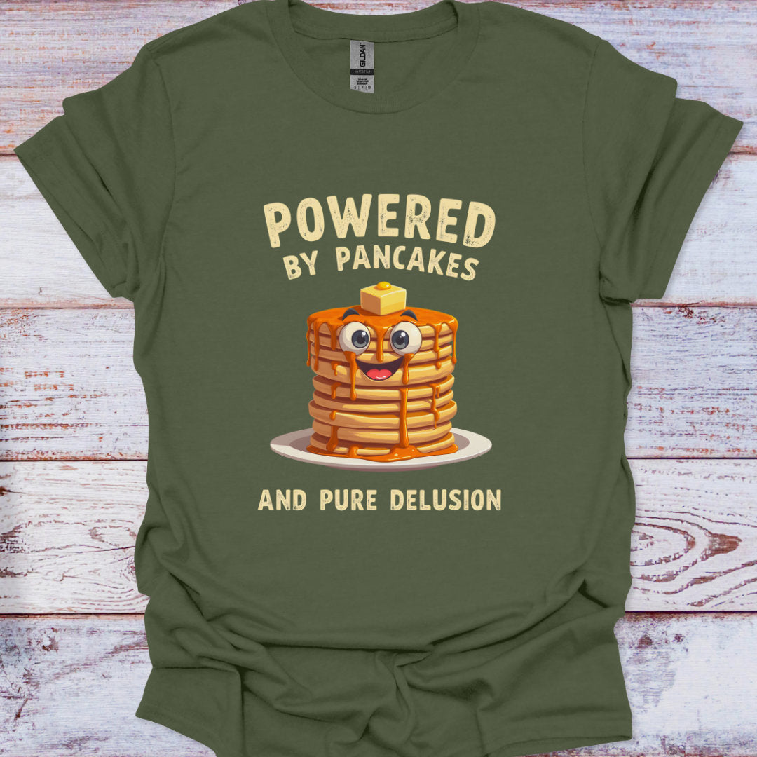 Green t-shirt with a cartoon stack of pancakes and text on a wooden surface