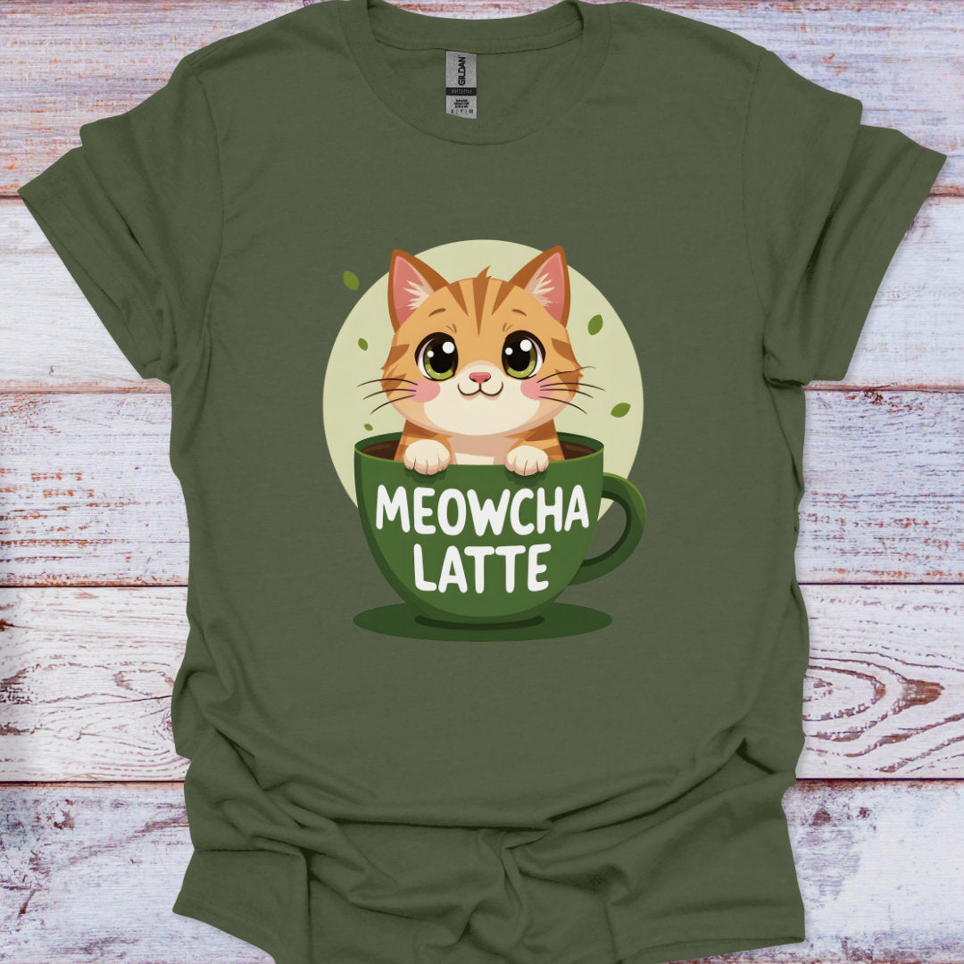 Green t-shirt with a cat in a coffee cup graphic and 'MEOWCHA LATTE' text on a wooden surface.
