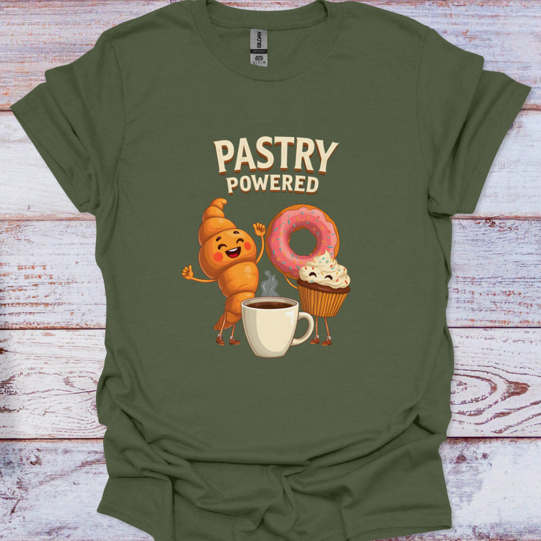 Green t-shirt with cartoon characters and 'Pastry Powered' text on a wooden surface