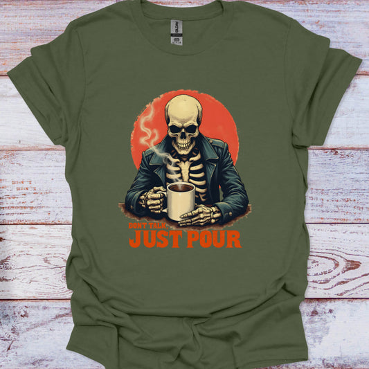 Green t-shirt with a skeleton holding a cup and 'Just Pour' text on a wooden surface