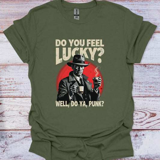Green t-shirt with a graphic of a man in a hat holding a cup, text 'Do You Feel Lucky? Well, Do Ya, Punk?' on a wooden background.