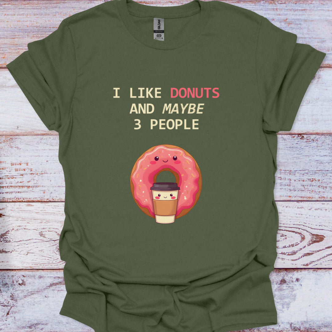 Green t-shirt with a donut graphic and text on a wooden surface