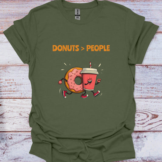 Green t-shirt with cartoon donut and coffee cup design and 'DONUTS > PEOPLE' text on a wooden surface.