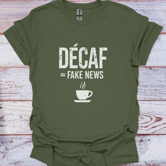 Green t-shirt with 'Décaf = Fake News' text and coffee cup graphic on a wooden surface