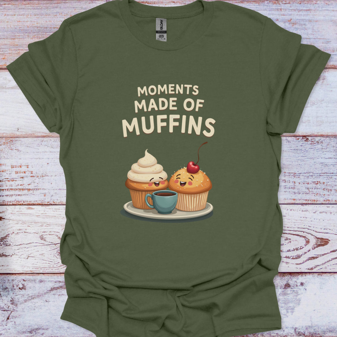 Green t-shirt with cartoon muffins and text 'Moments Made of Muffins' on a wooden surface
