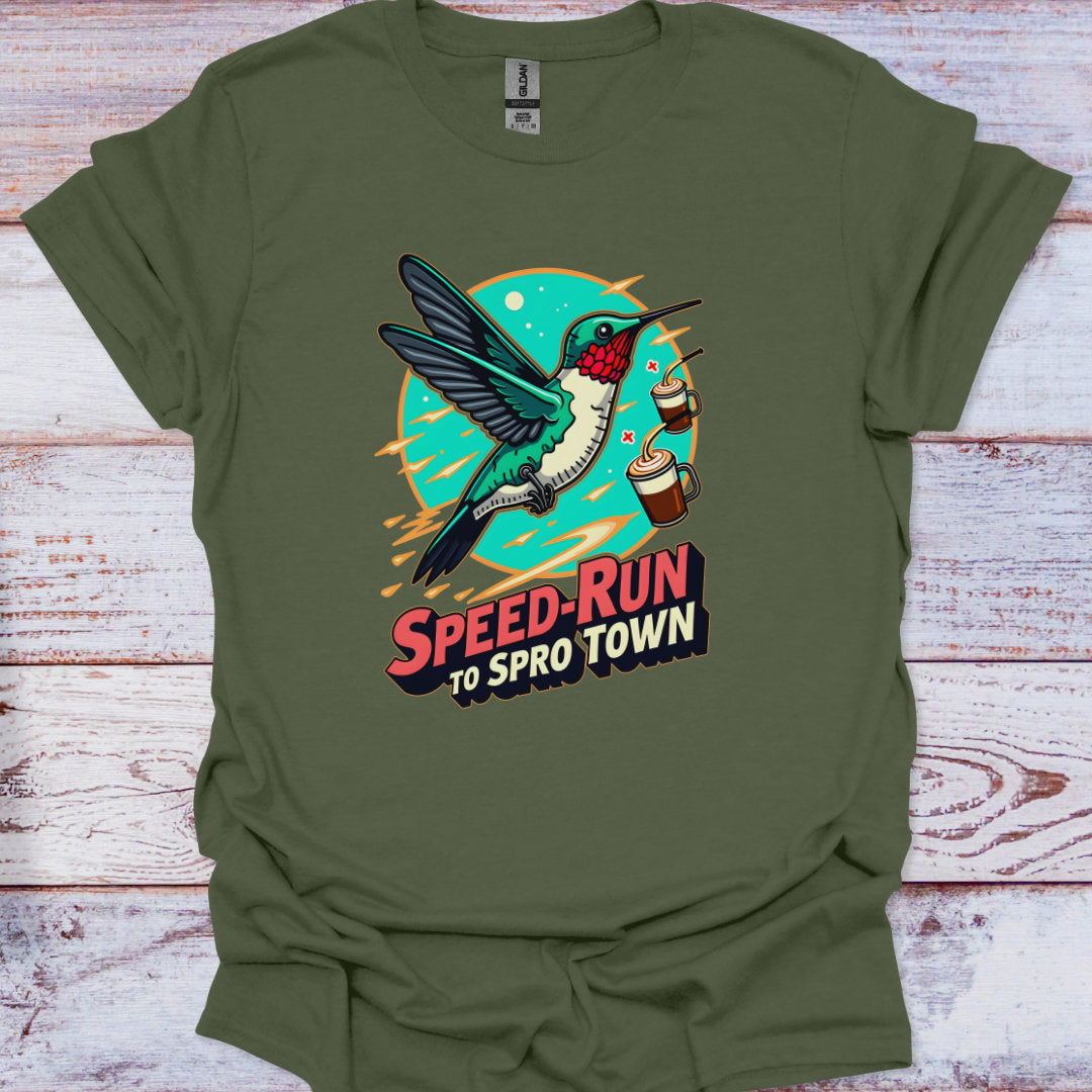 Green t-shirt with a hummingbird graphic and text on a wooden surface