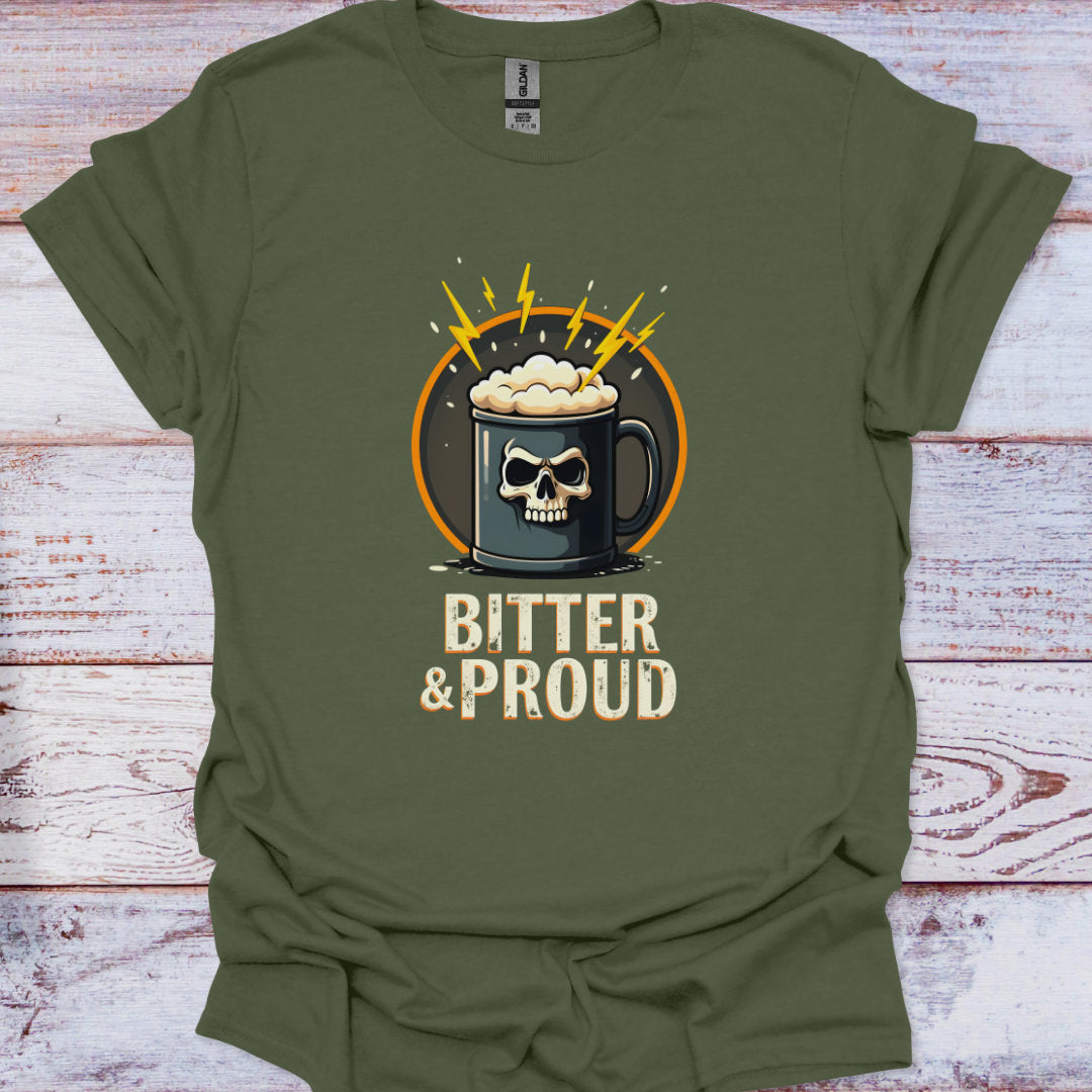 Green t-shirt with a skull and crossbones design and 'Bitter & Proud' text on a wooden surface.