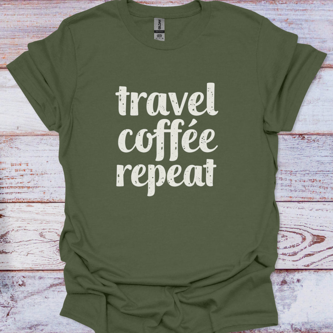 Green t-shirt with 'travel coffee repeat' text on a wooden surface