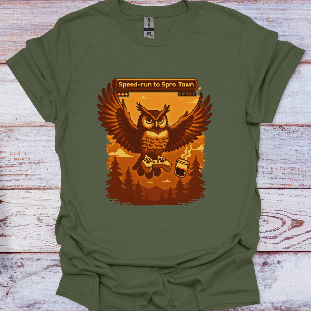 Green t-shirt with an owl graphic and text on a wooden surface