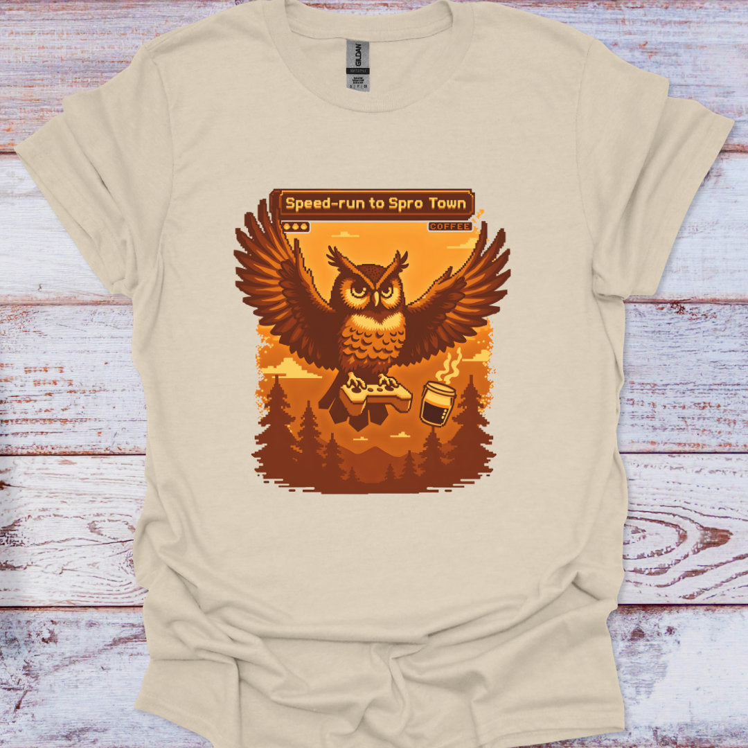 Beige t-shirt with an owl graphic and text on a wooden surface
