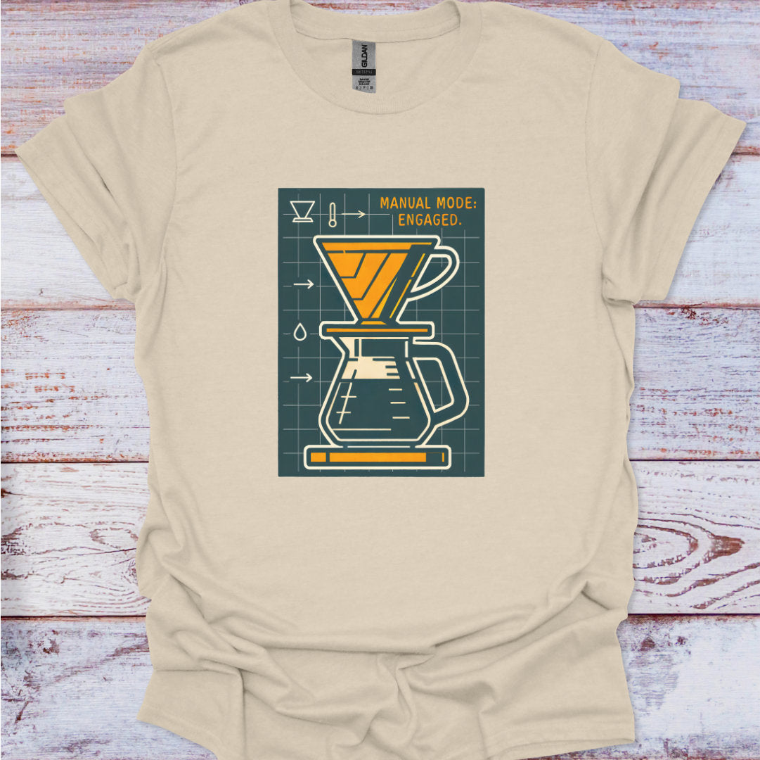 Beige t-shirt with a coffee brewing graphic on a wooden surface