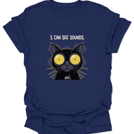 A navy blue graphic t-shirt depicting an electrified black cat in a state of caffeine-induced euphoria with the text "I CAN SEE SOUNDS" printed above the artwork.